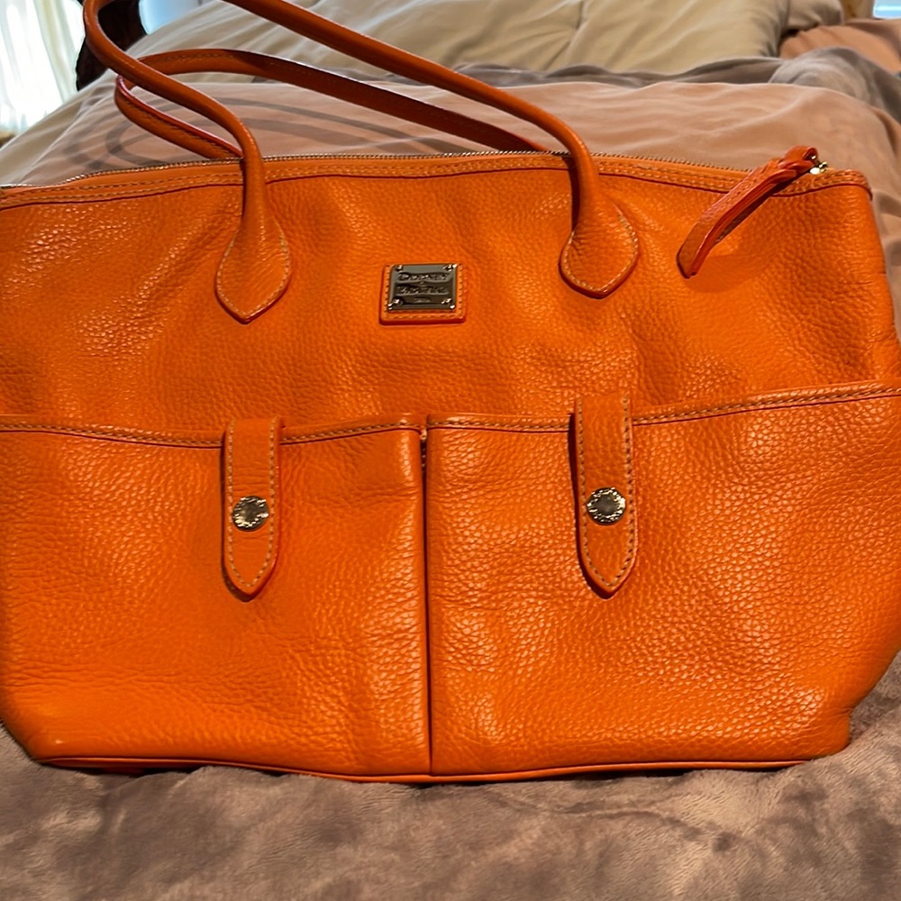 Dooney, orange, inside has some stains but otherwise in good condition!